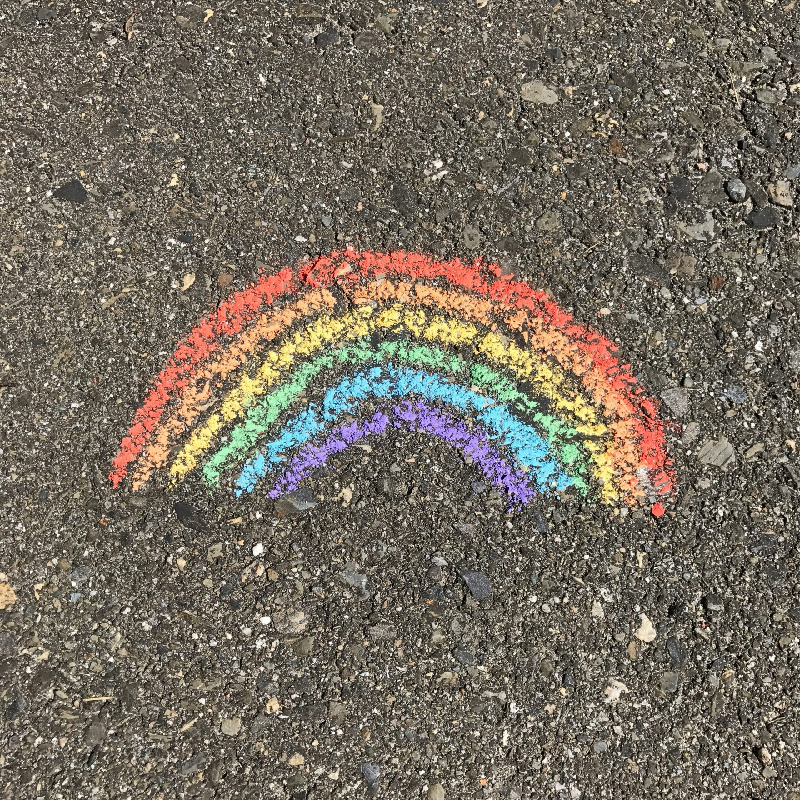 A child's chalk drawing of a rainbow symbolising our inclusive values outside Collinwood Road United Reformed Church in Oxford